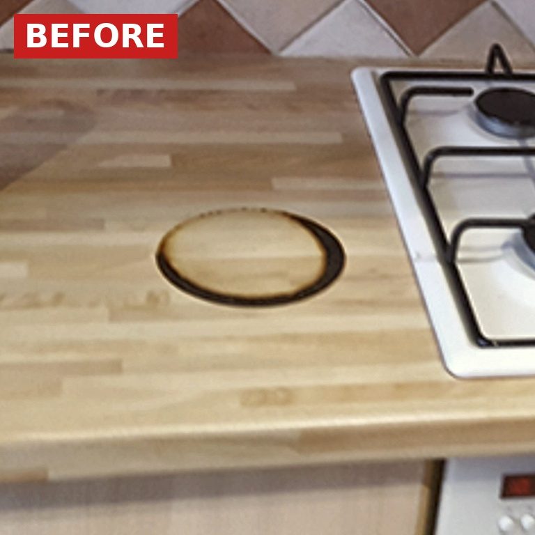 Worktop with a round burn mark (before) Burnt worktop: Wooden kitchen worktop with burn mark before repair